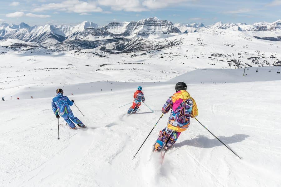 2 person in yellow jacket and blue helmet riding ski blades on snow covered mountain during, Vacanțe la ski — CautaVacanta.ro