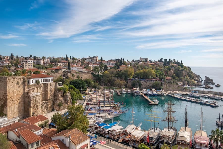 a harbor filled with lots of boats next to a city, Antalya — CautaVacanta.ro